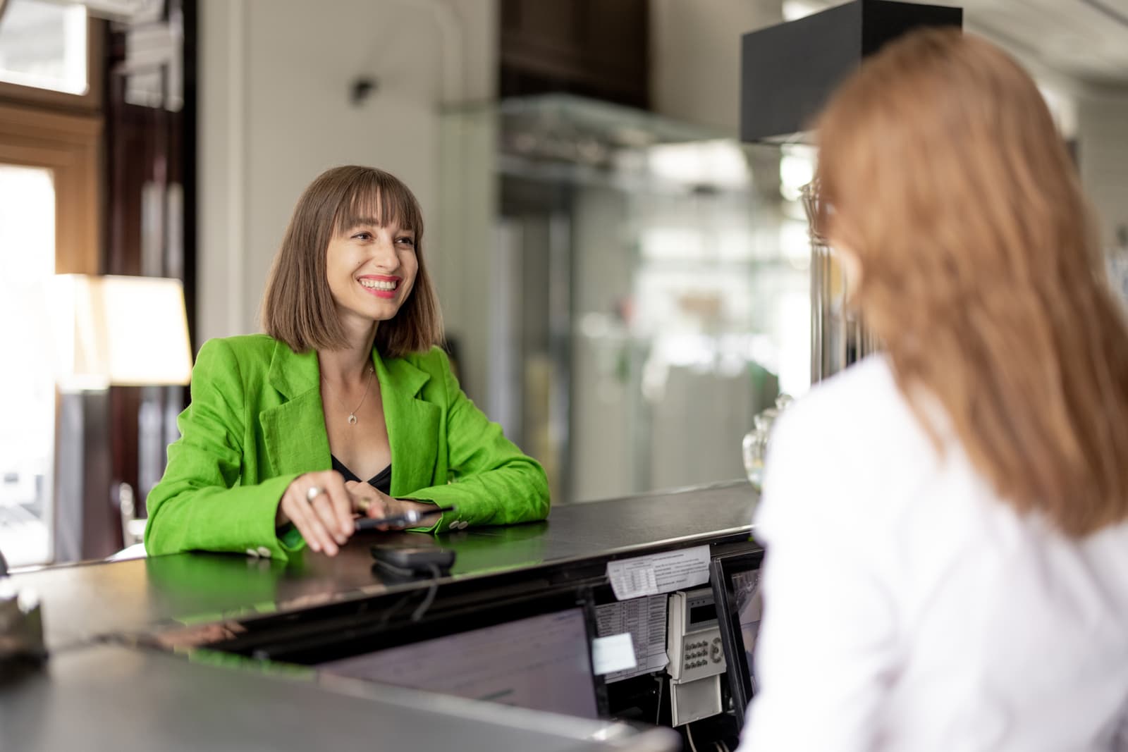 a women scanning her mobile ID at hotel check using her phone